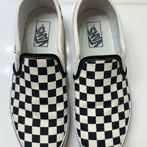 Vans iconic checkerboard print slip-on black and white sneakers.